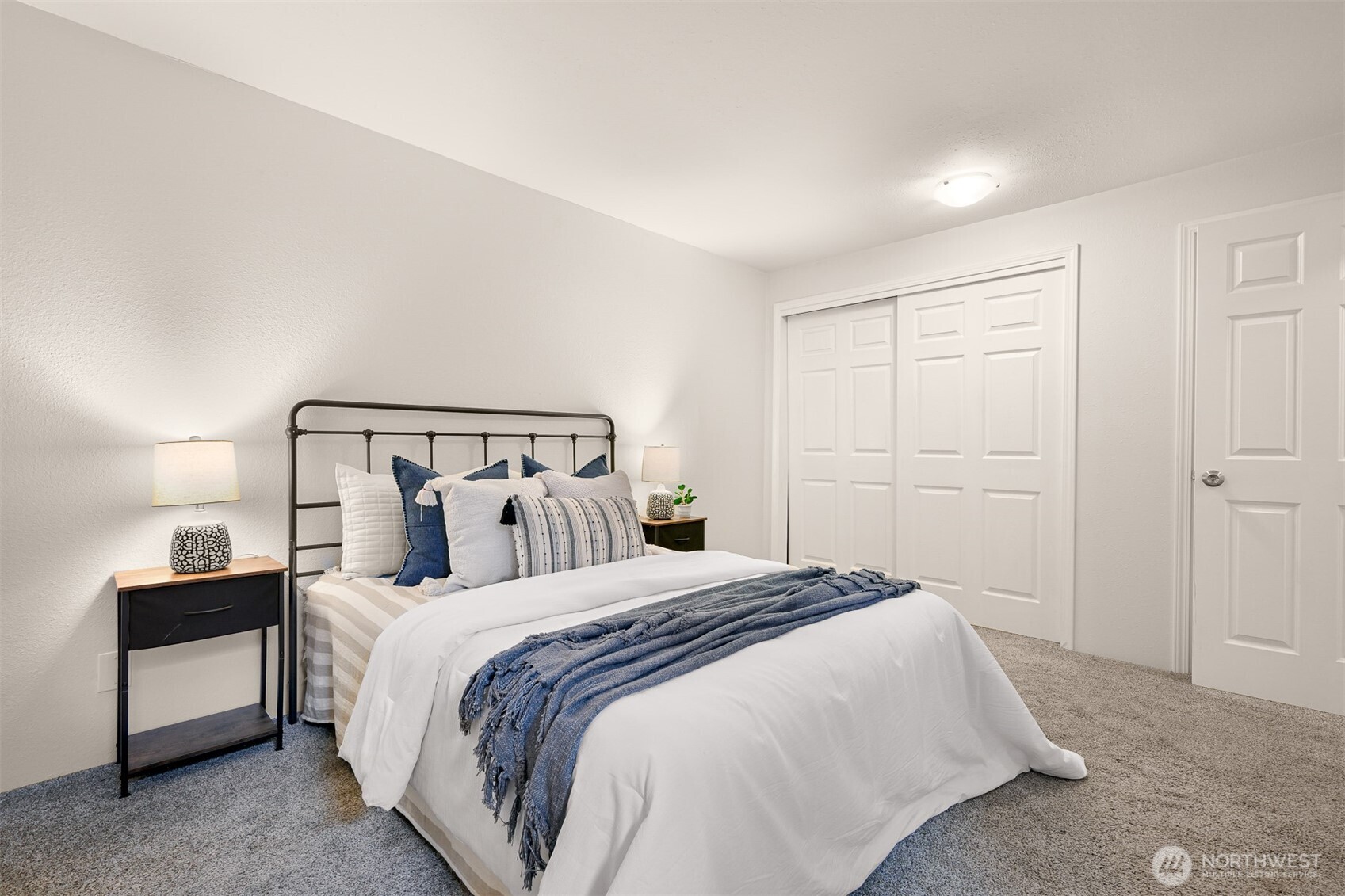 444 South State Street, Unit 317 Bellingham, WA 98225 - Photo 14 of 27 a bedroom with a bed and a lamp