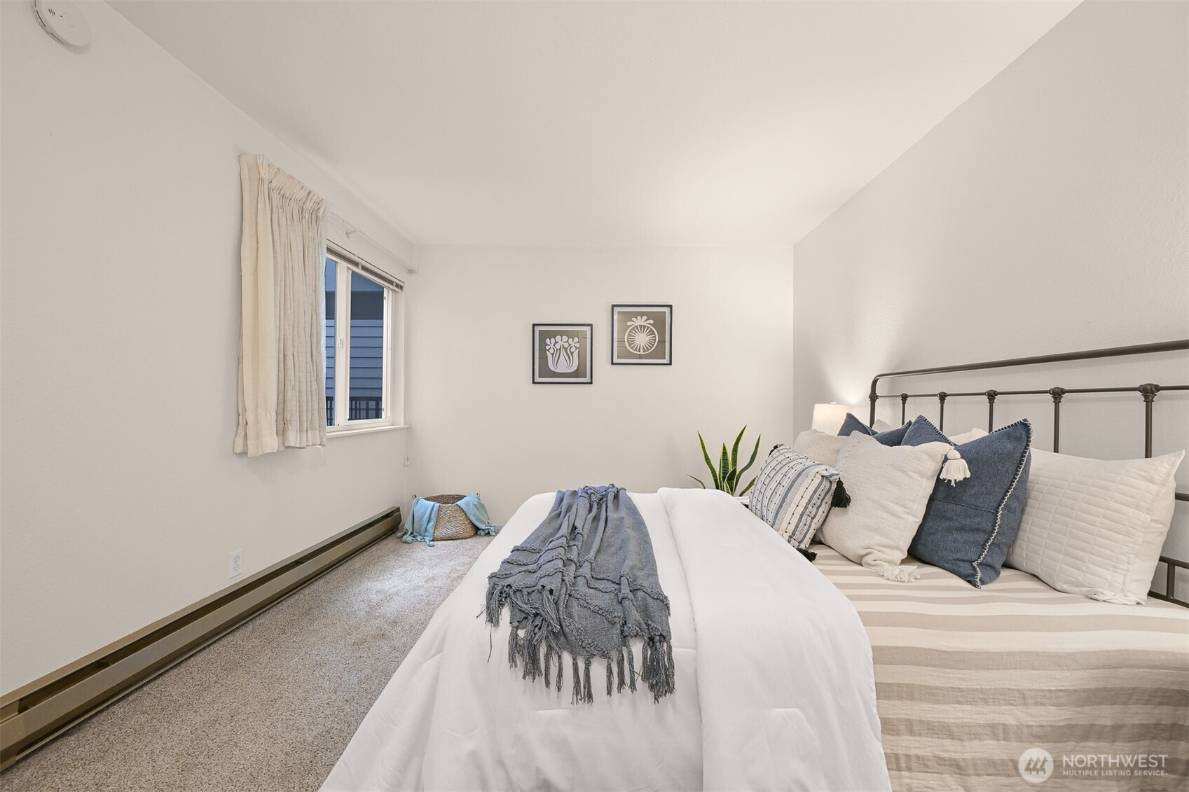 444 South State Street, Unit 317 Bellingham, WA 98225 - Photo 15 of 27 a bedroom with a bed and painting on the wall