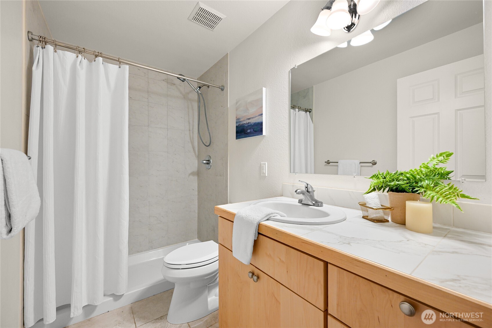 444 South State Street, Unit 317 Bellingham, WA 98225 - Photo 17 of 27 a bathroom with a sink a toilet and a mirror