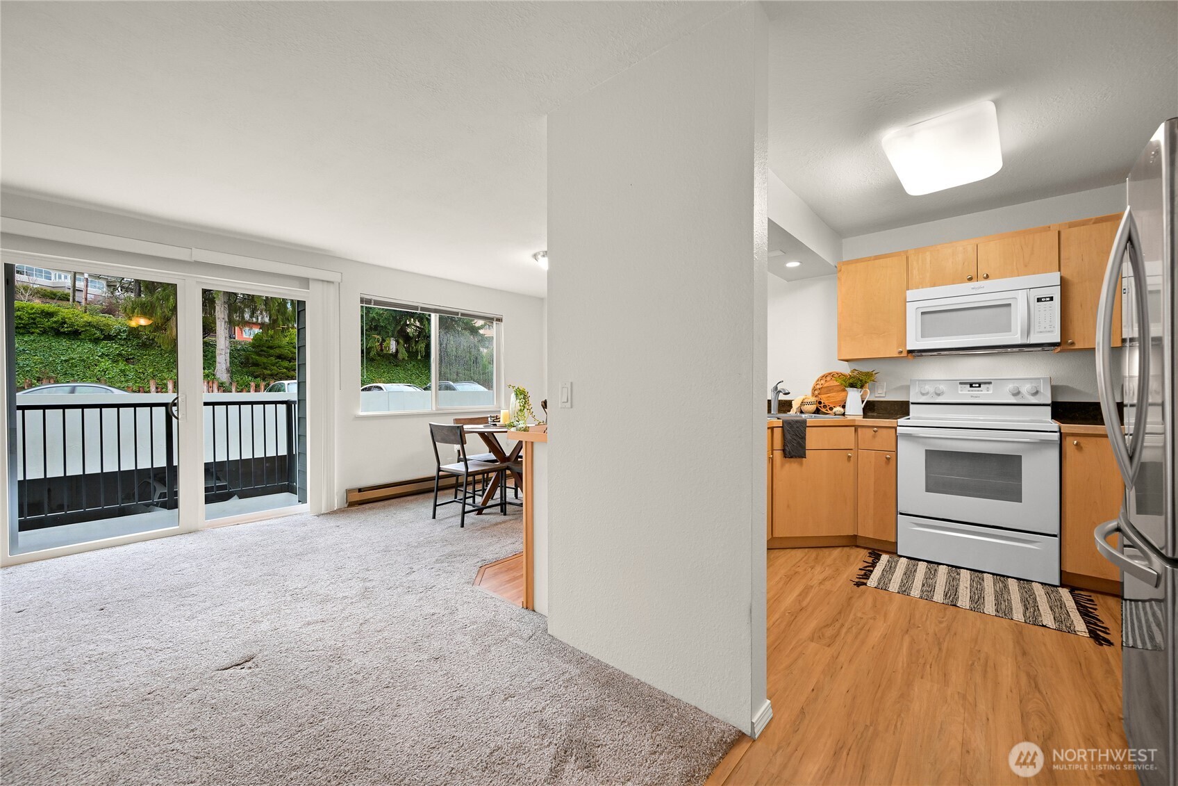 444 South State Street, Unit 317 Bellingham, WA 98225 - Photo 7 of 27 a view of a kitchen with furniture and wooden floor