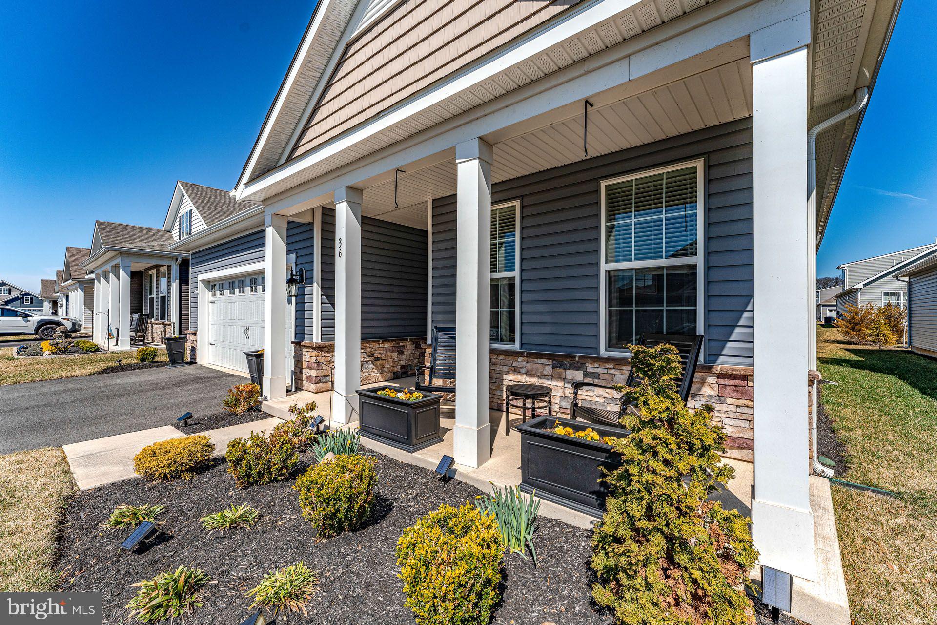 36 Walton Way Delanco, NJ 08075 - Photo 2 of 39 a front view of a house with outdoor seating and a potted plant