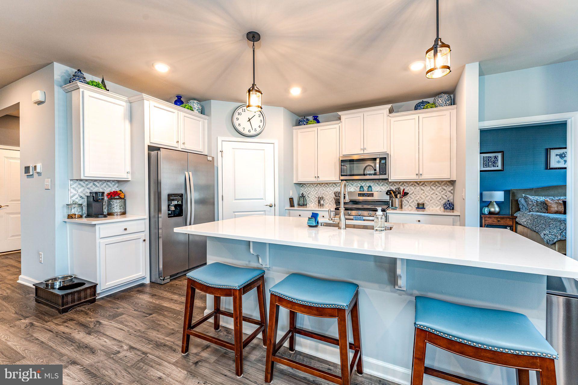 36 Walton Way Delanco, NJ 08075 - Photo 7 of 39 a kitchen with stainless steel appliances a dining table chairs refrigerator and sink