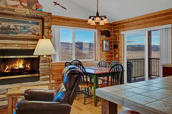 a living room with furniture a flat screen tv and kitchen view