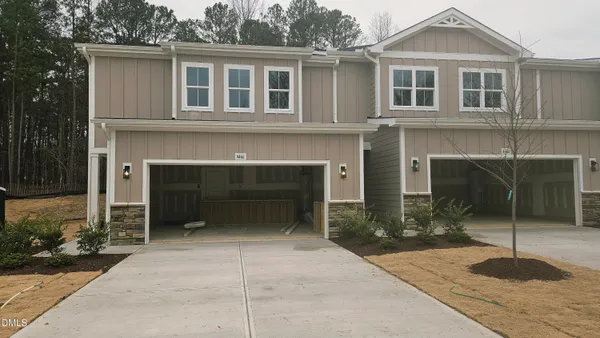 a front view of a house with yard