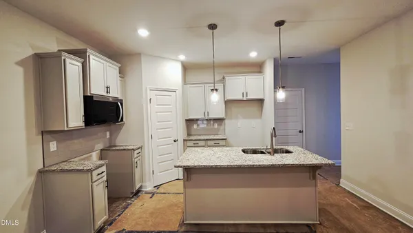 a kitchen with kitchen island a sink stainless steel appliances and counter space