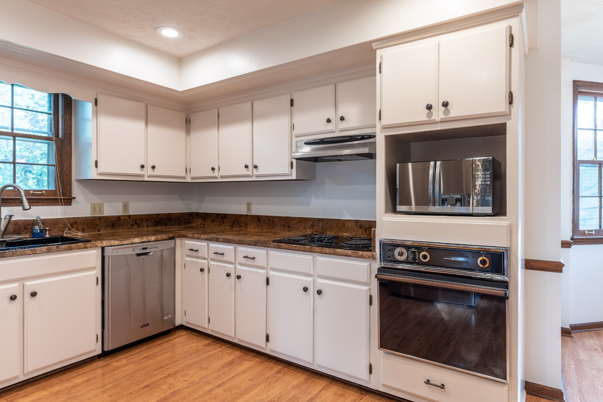 6948 Stone Creek Road Nashville, TN 37221 - Photo 11 of 37 a kitchen with granite countertop white cabinets and stainless steel appliances
