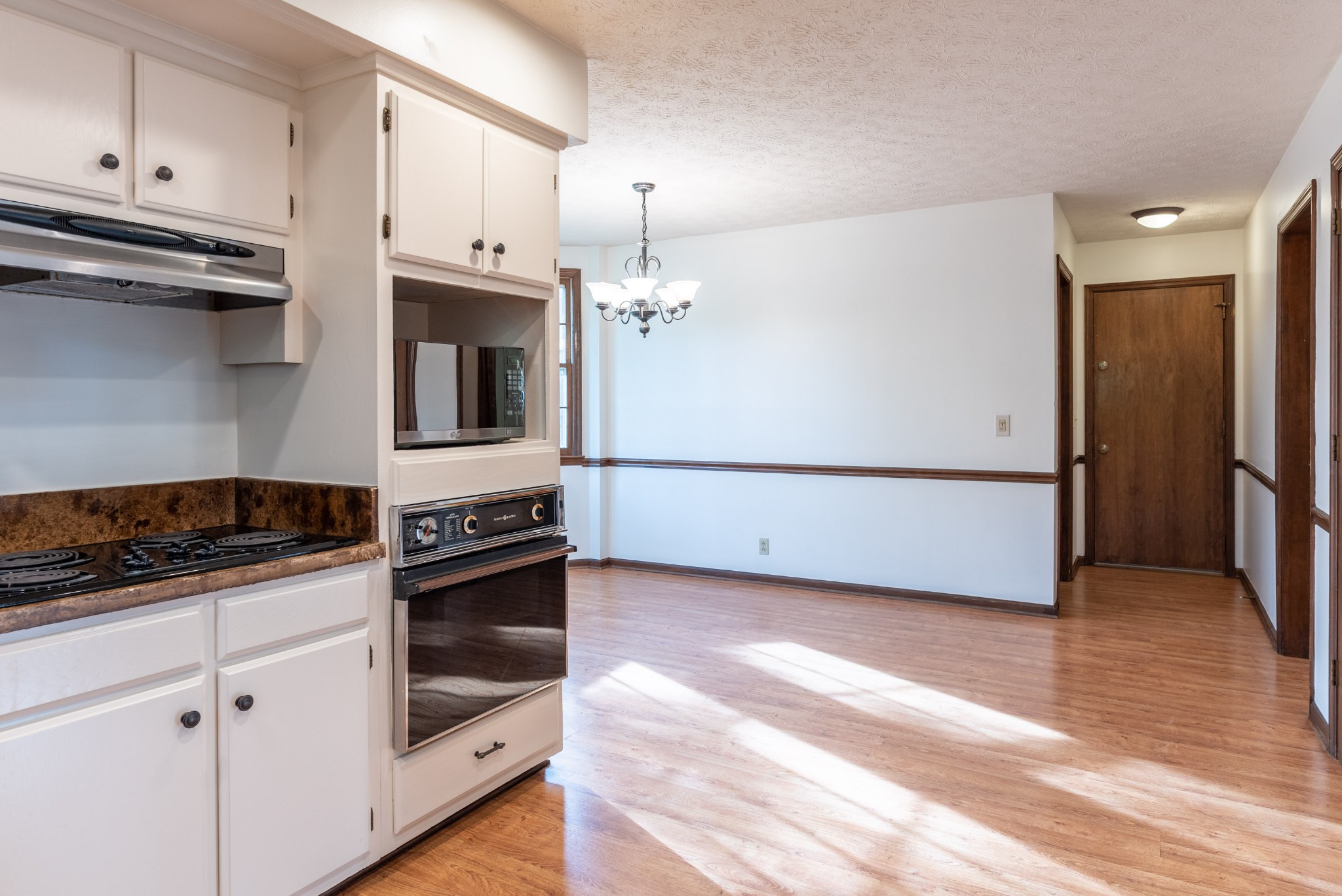 6948 Stone Creek Road Nashville, TN 37221 - Photo 12 of 37 a kitchen with granite countertop white cabinets and stainless steel appliances