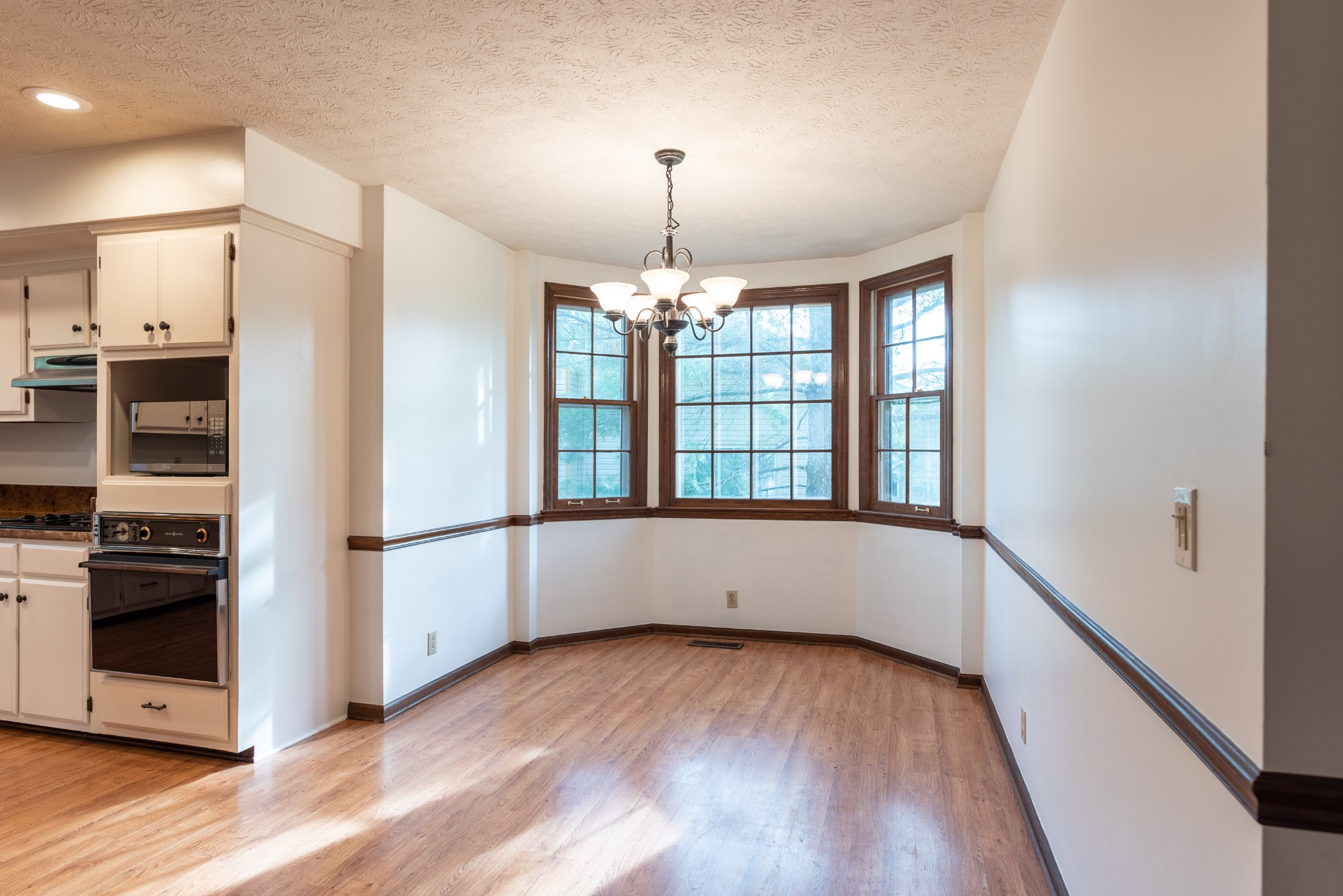6948 Stone Creek Road Nashville, TN 37221 - Photo 13 of 37 a view of an empty room with a window and wooden floor