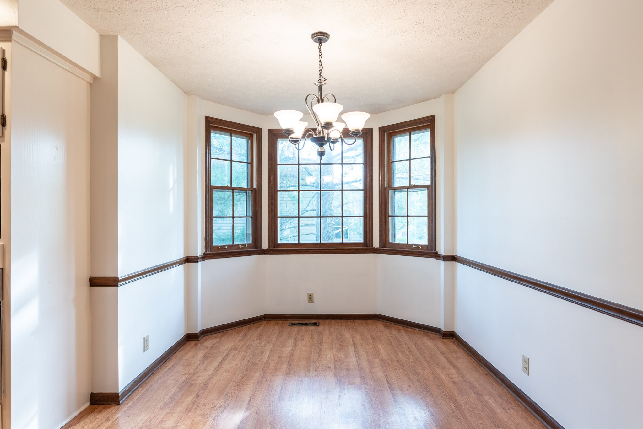 6948 Stone Creek Road Nashville, TN 37221 - Photo 14 of 37 a view of an empty room with wooden floor and a window