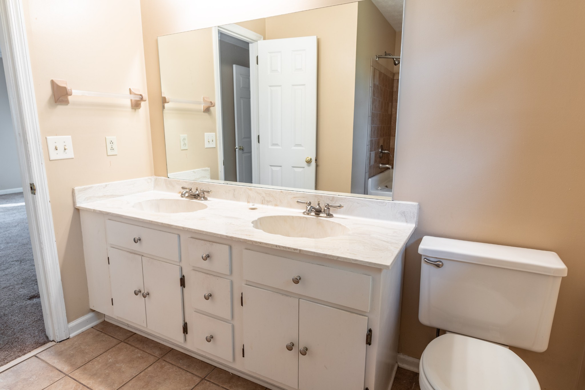 6948 Stone Creek Road Nashville, TN 37221 - Photo 24 of 37 a bathroom with a granite countertop toilet sink and mirror