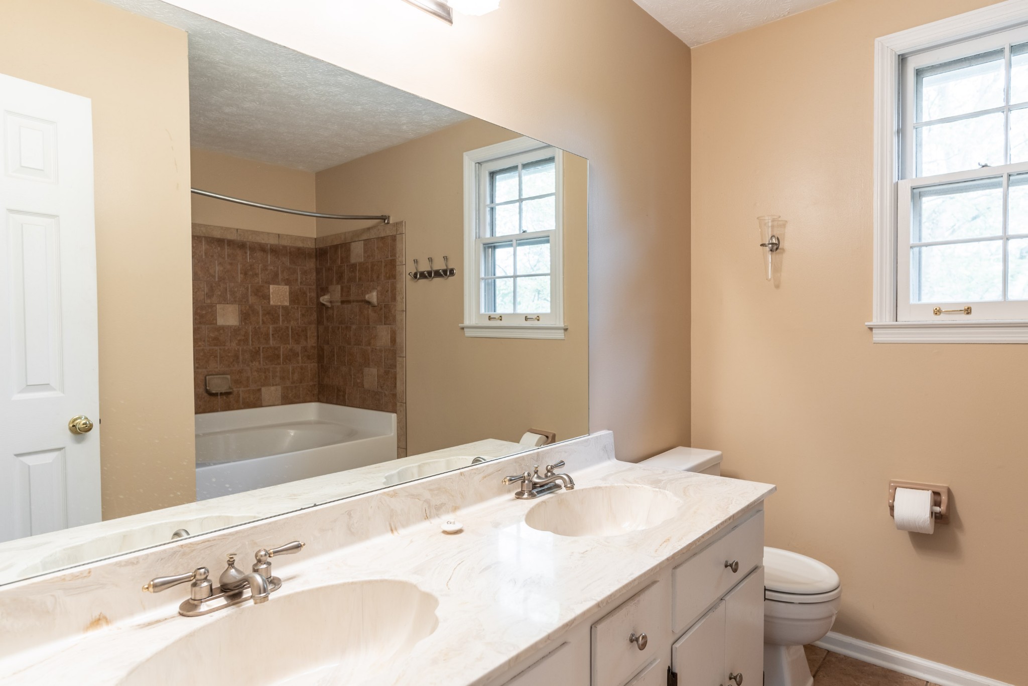 6948 Stone Creek Road Nashville, TN 37221 - Photo 25 of 37 a bathroom with a sink and a mirror