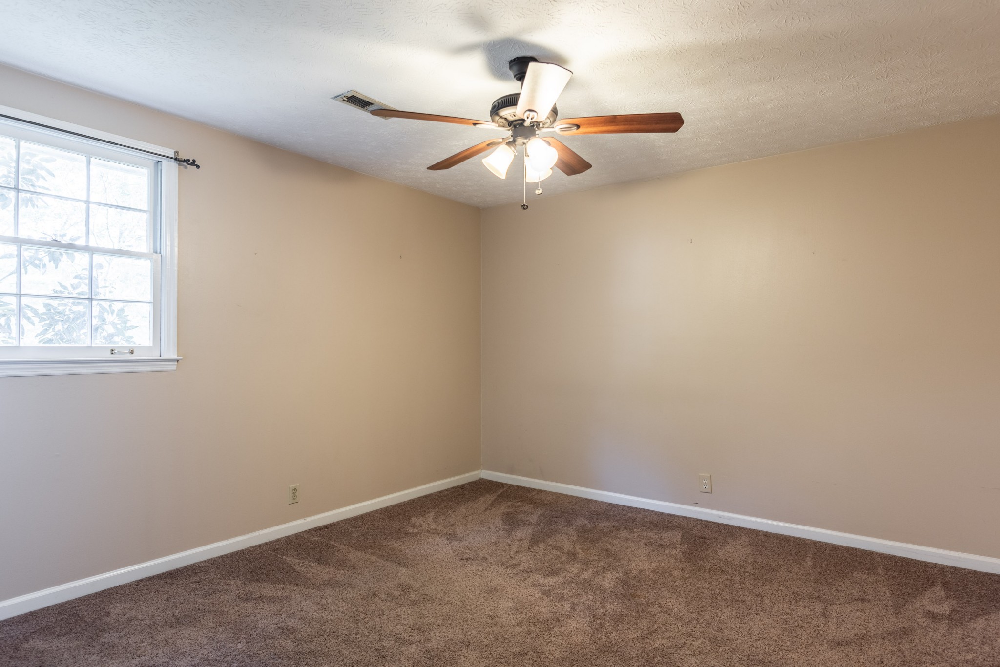 6948 Stone Creek Road Nashville, TN 37221 - Photo 29 of 37 an empty room with a window and a fan