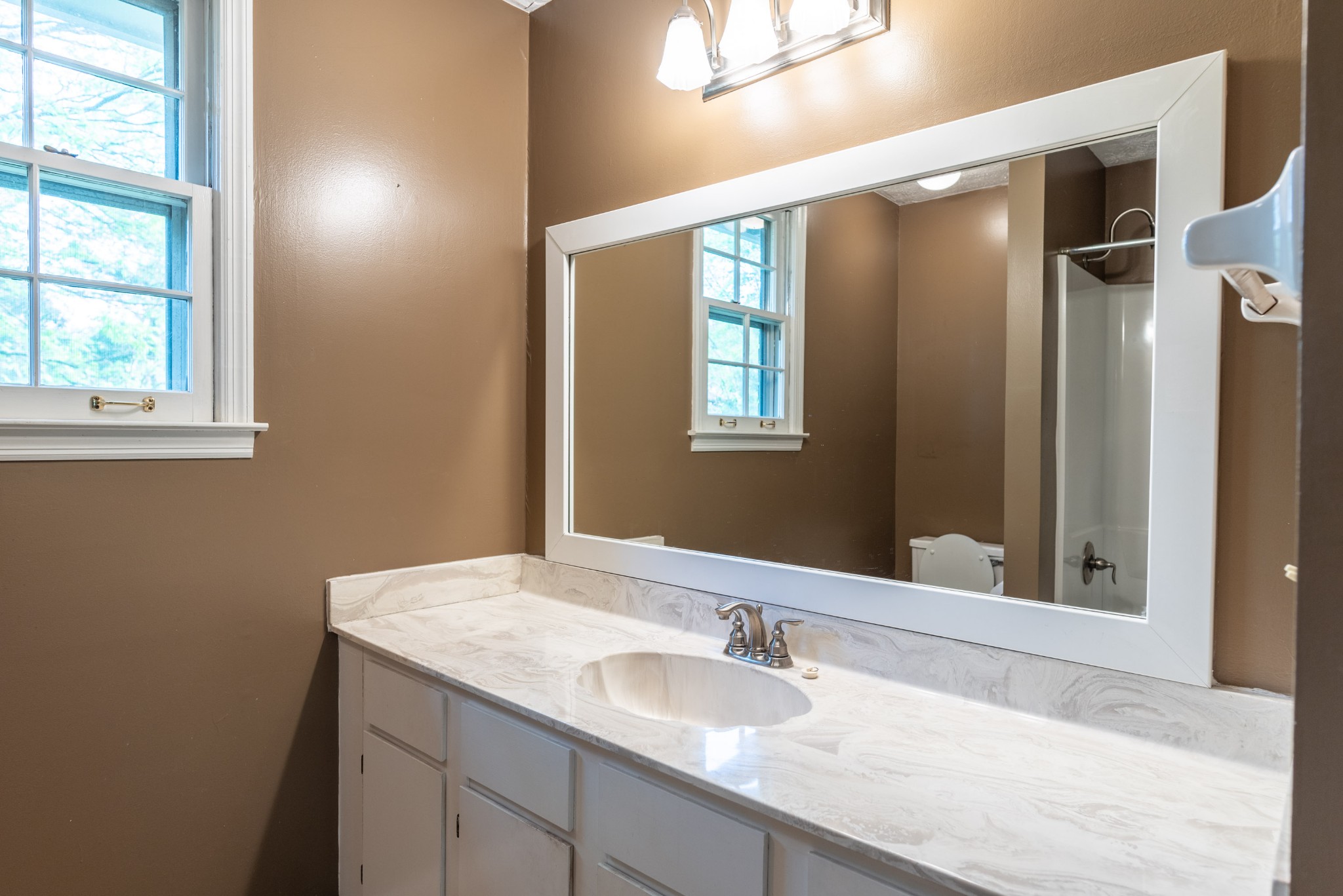 6948 Stone Creek Road Nashville, TN 37221 - Photo 30 of 37 a bathroom with a granite countertop sink mirror and double