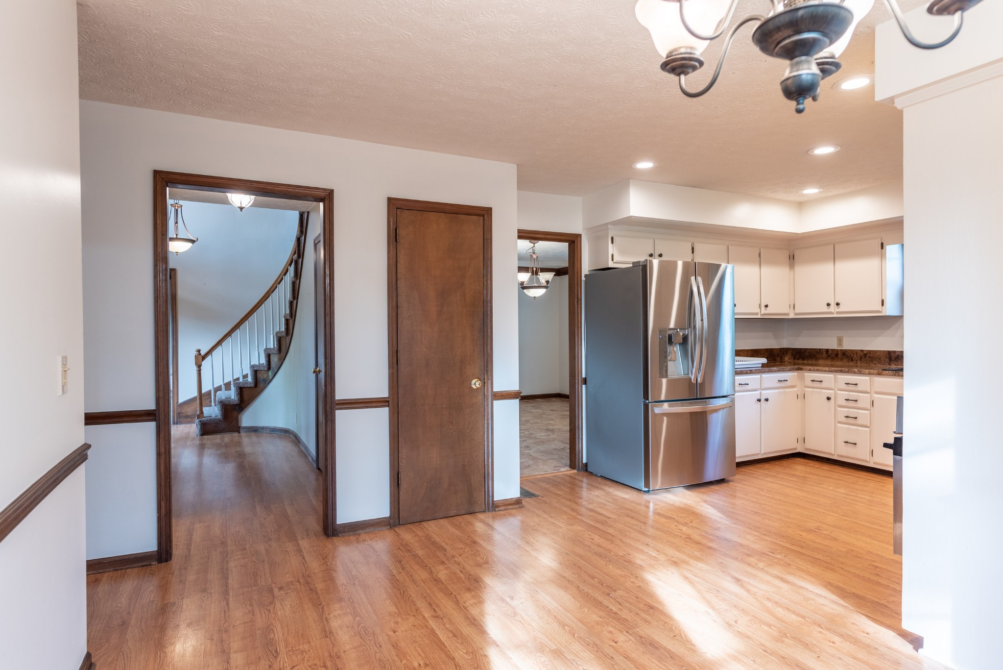 6948 Stone Creek Road Nashville, TN 37221 - Photo 8 of 37 a kitchen with stainless steel appliances a refrigerator and a view of living room