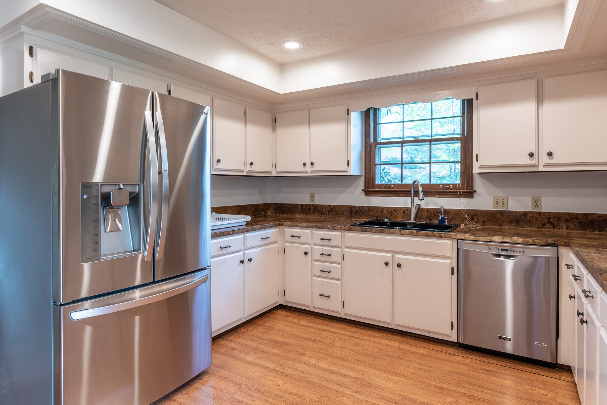 6948 Stone Creek Road Nashville, TN 37221 - Photo 10 of 37 a kitchen with granite countertop a refrigerator sink and cabinets