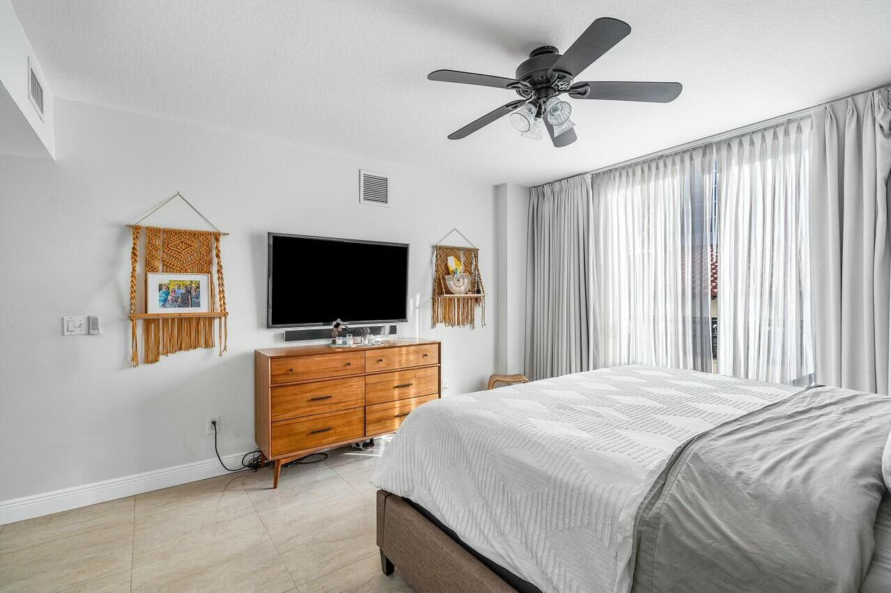 600 South Dixie Highway, Unit 331 West Palm Beach, FL 33401 - Photo 18 of 39 a bedroom with a bed and a flat screen tv