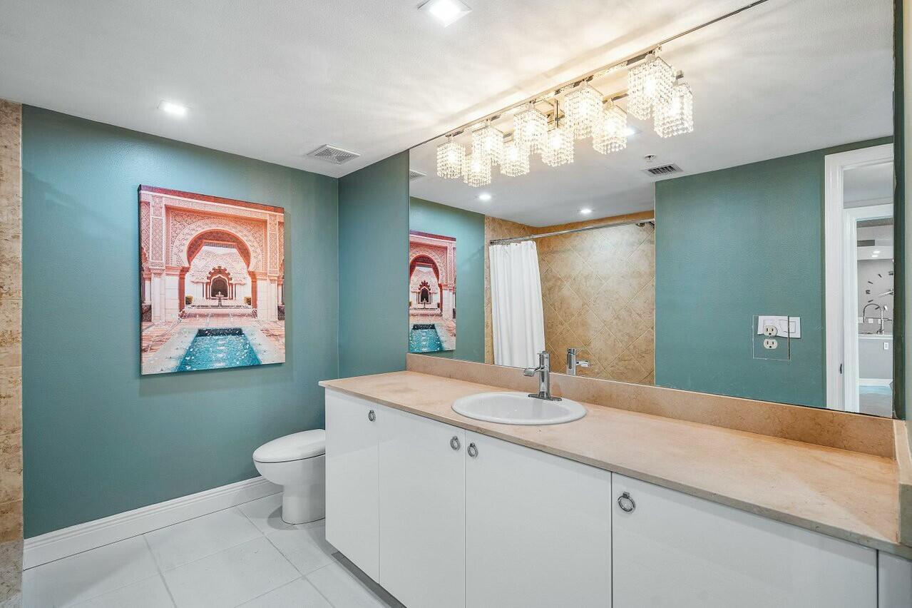 600 South Dixie Highway, Unit 331 West Palm Beach, FL 33401 - Photo 25 of 39 a bathroom with a double vanity sink mirror and toilet