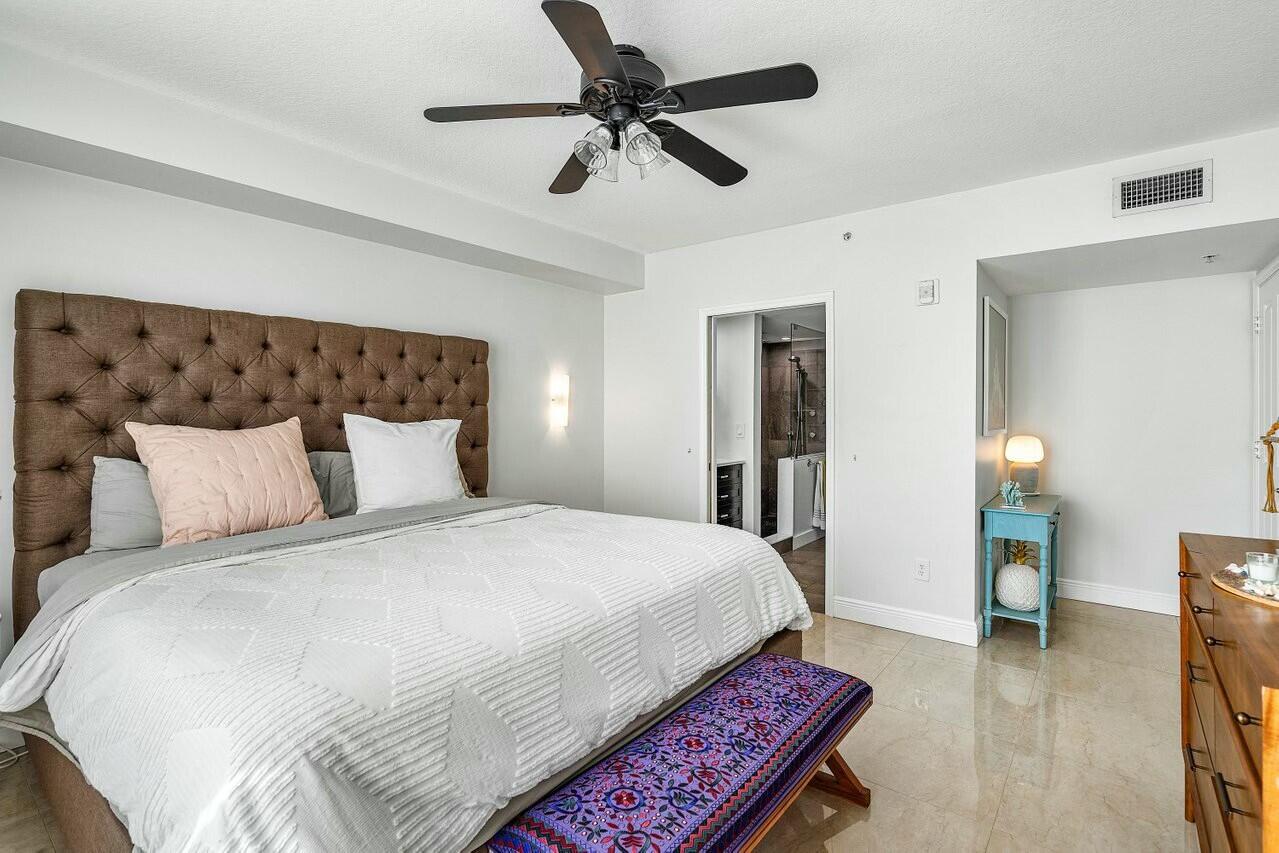 600 South Dixie Highway, Unit 331 West Palm Beach, FL 33401 - Photo 30 of 39 a bedroom with a bed and a chandelier