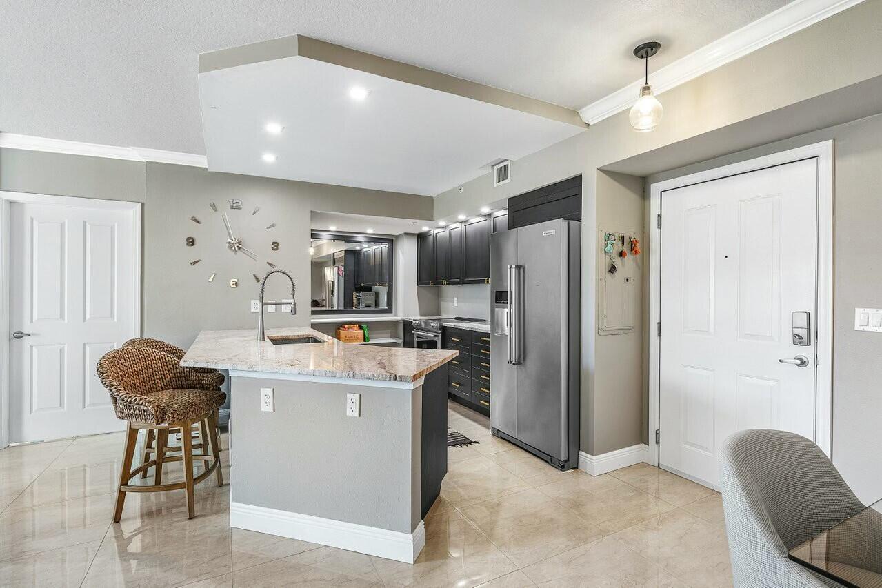 600 South Dixie Highway, Unit 331 West Palm Beach, FL 33401 - Photo 8 of 39 a view of kitchen with stainless steel appliances kitchen island granite countertop dining table and chairs