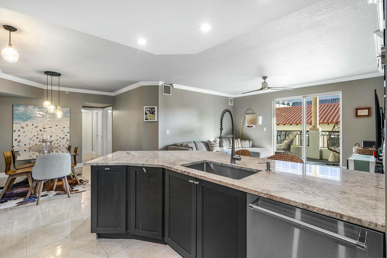 600 South Dixie Highway, Unit 331 West Palm Beach, FL 33401 - Photo 9 of 39 a kitchen with granite countertop a sink and cabinets