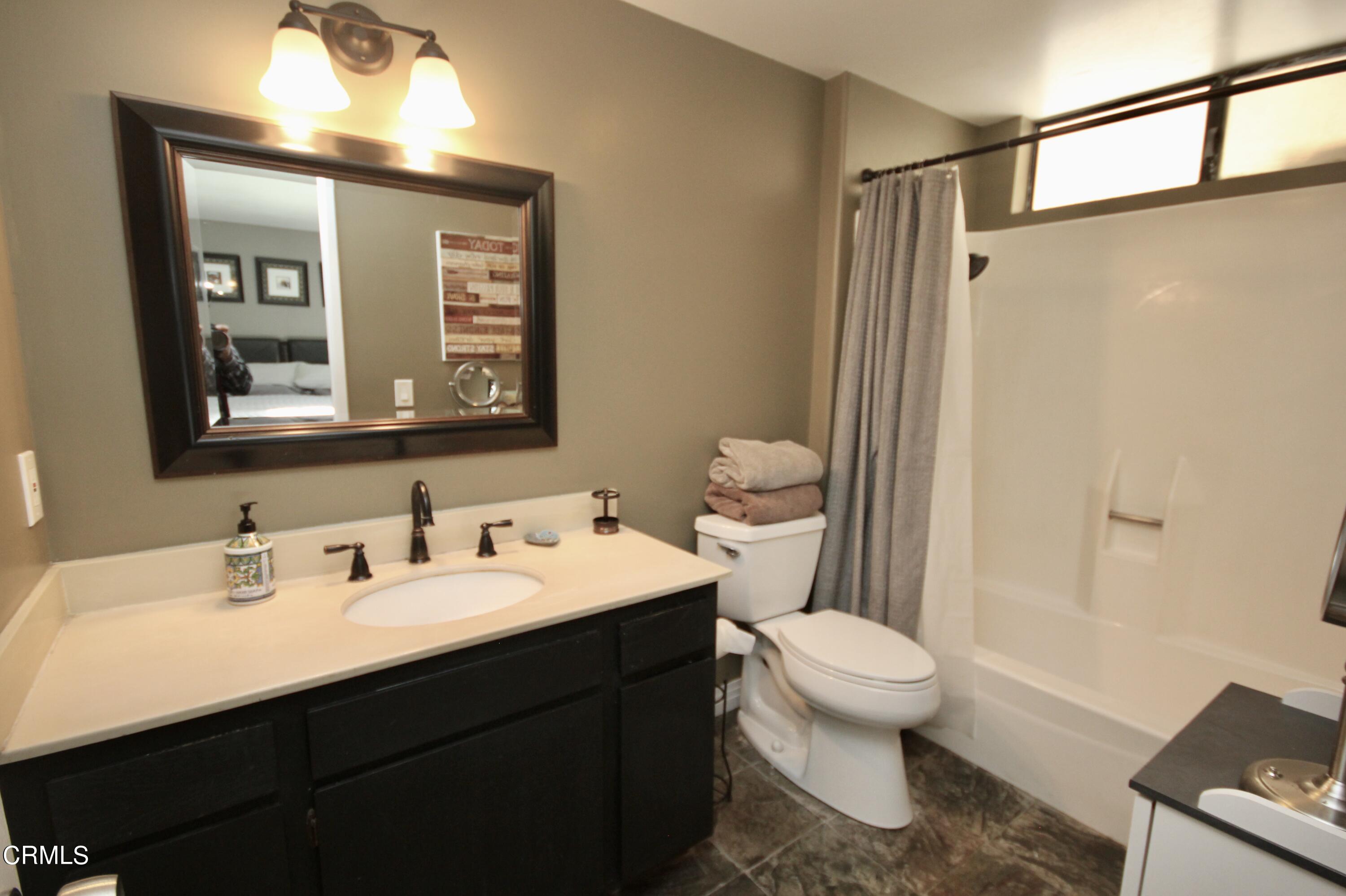 1966 Sutter Place Oxnard, CA 93033 - Photo 12 of 19 a bathroom with a sink a toilet a mirror and shower