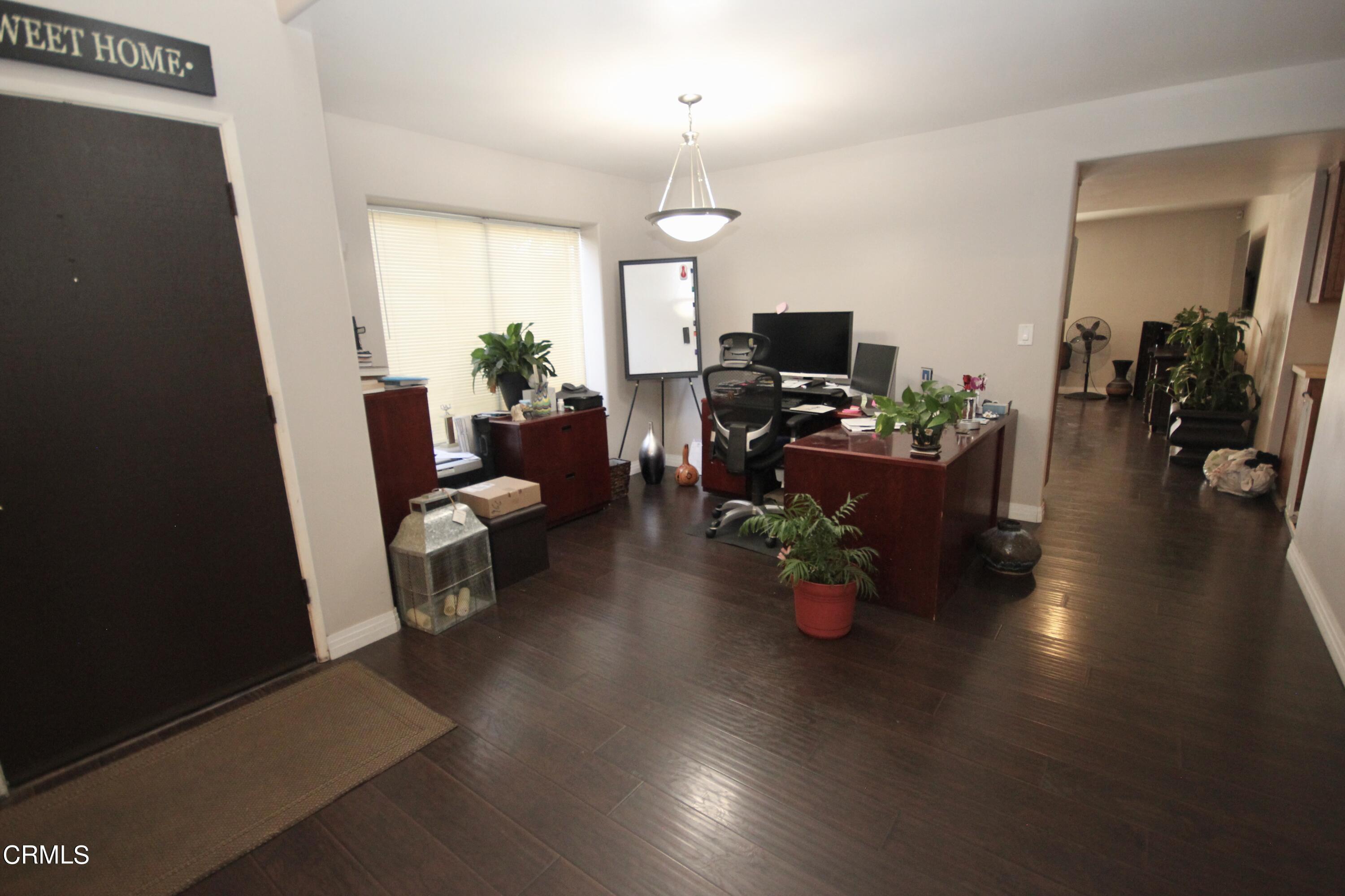 1966 Sutter Place Oxnard, CA 93033 - Photo 4 of 19 a living room with furniture and a chandelier