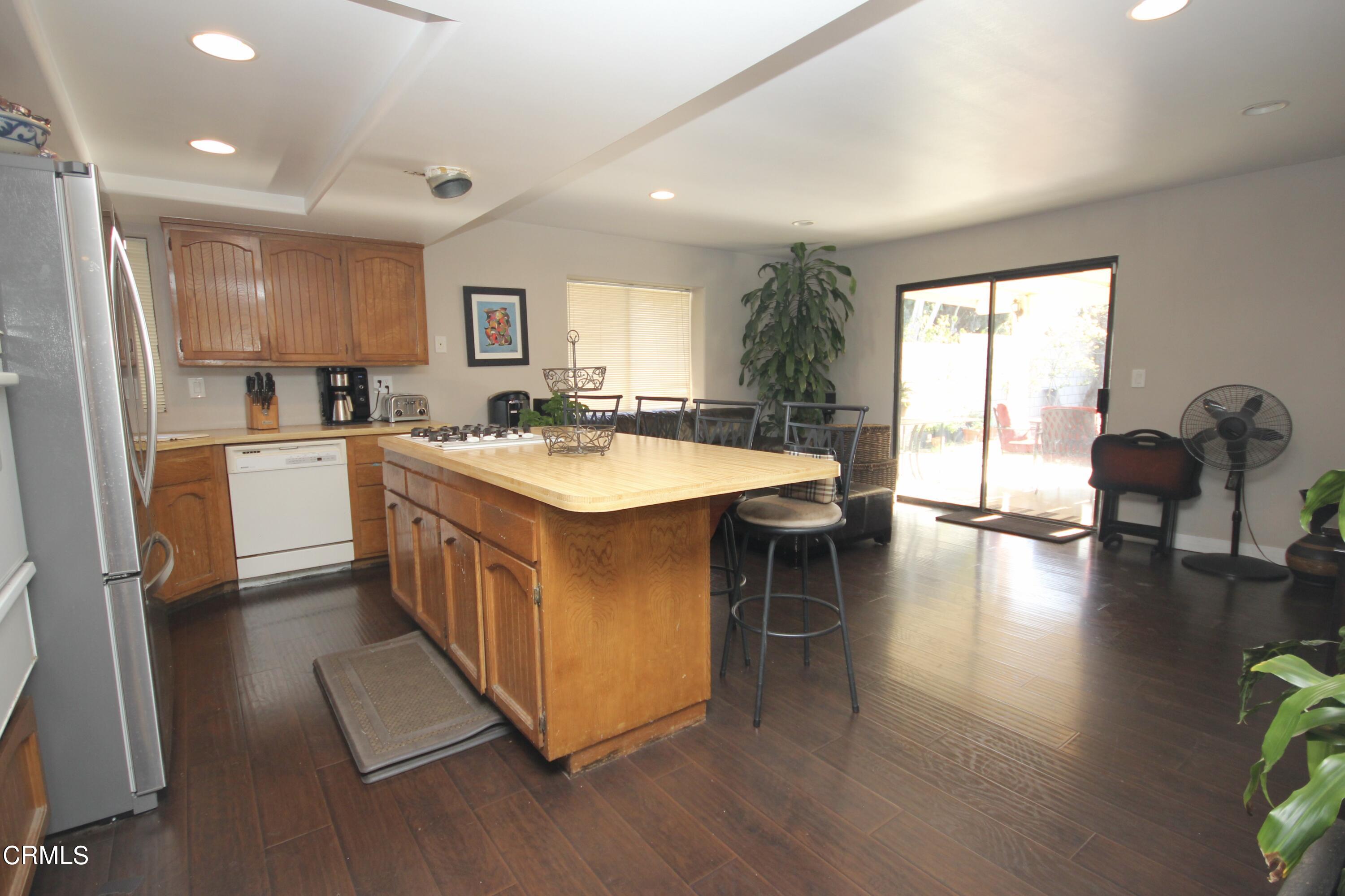 1966 Sutter Place Oxnard, CA 93033 - Photo 6 of 19 a kitchen with a sink stove and wooden cabinets