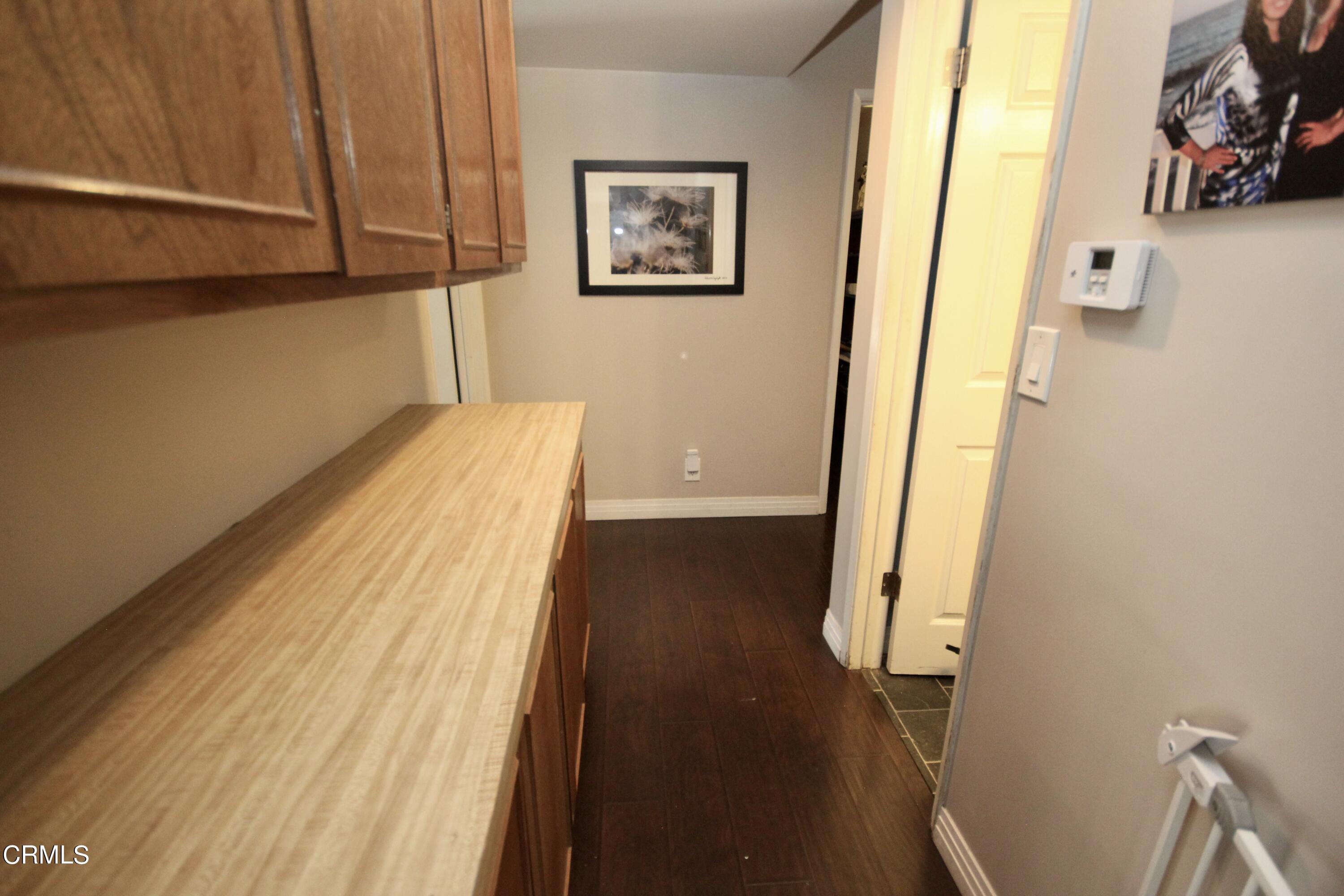 1966 Sutter Place Oxnard, CA 93033 - Photo 10 of 19 a view of a hallway with wooden floor and staircase