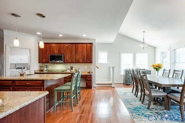 a view of a dining room with furniture and wooden floor