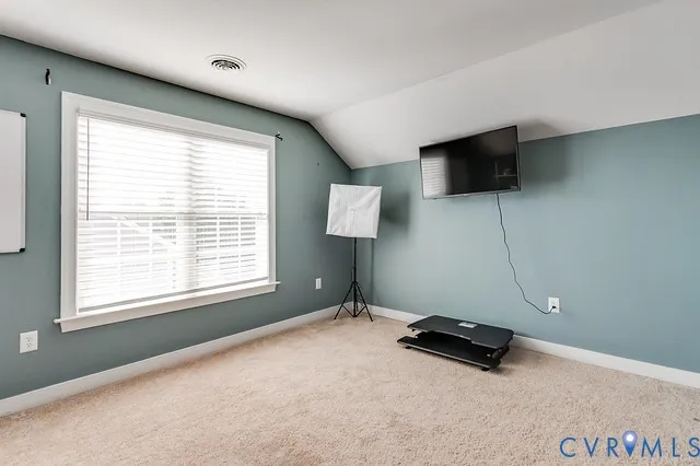 a room with gym equipment and a flat screen tv