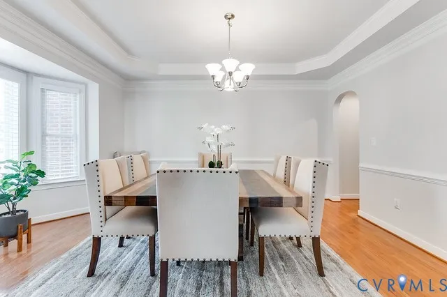 a view of a dining room with furniture wooden floor and chandelier