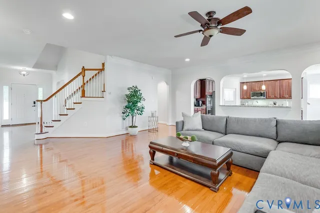 a living room with furniture and a ceiling fan