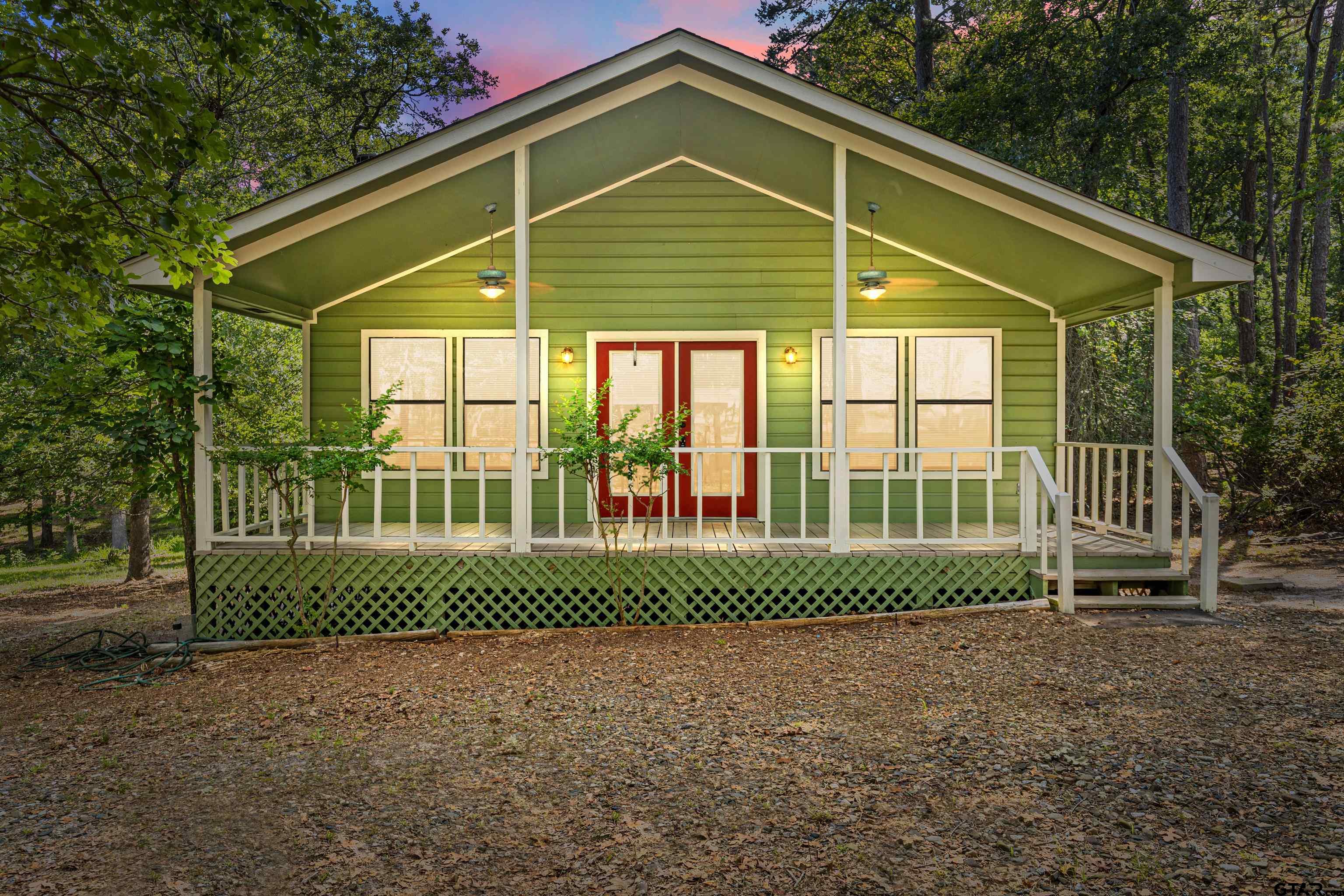 149 Primrose Path Holly Lake Ranch, TX 75765 - Photo 11 of 36 a view of a house with a yard and plants