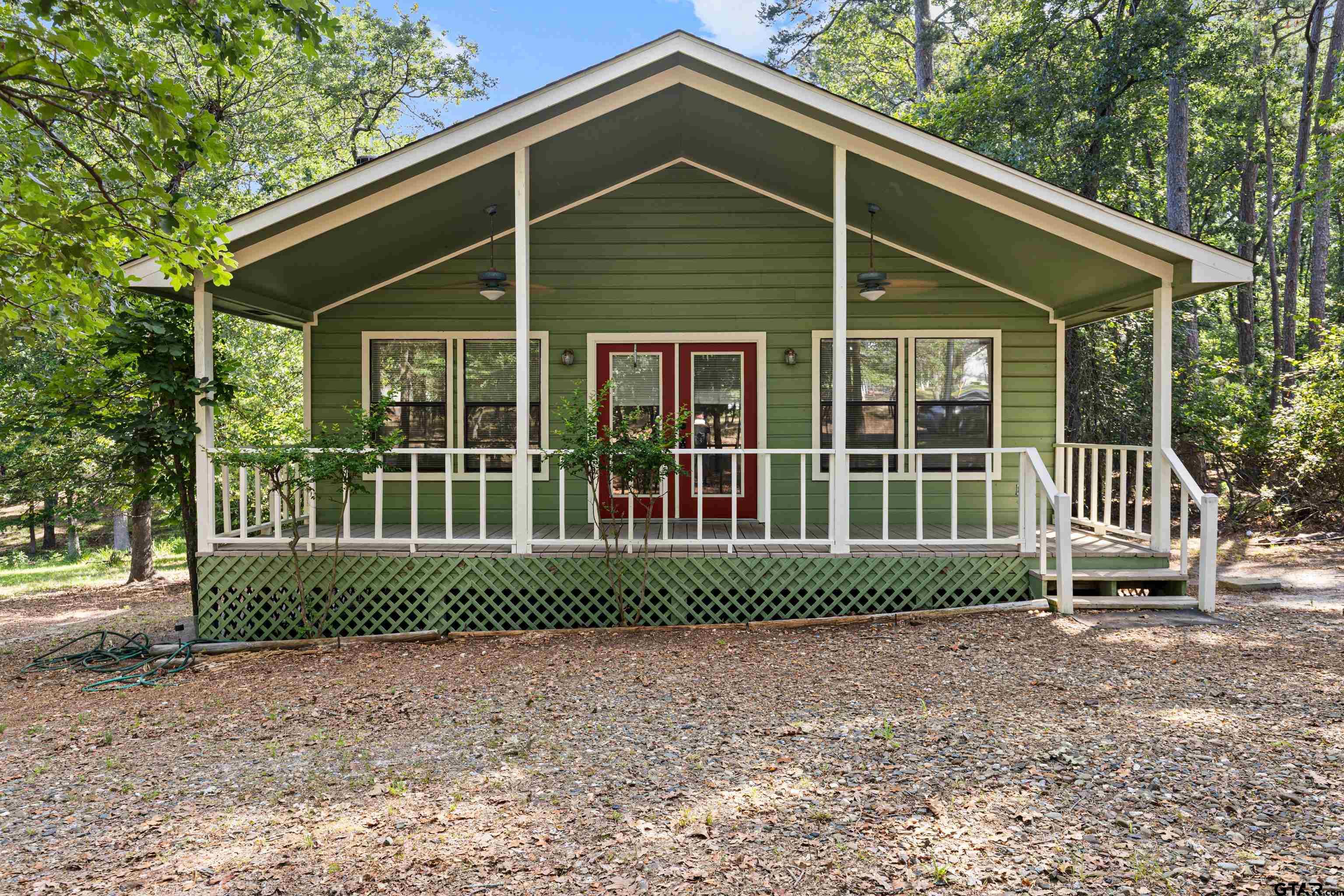 149 Primrose Path Holly Lake Ranch, TX 75765 - Photo 12 of 36 a front view of a house with a garden