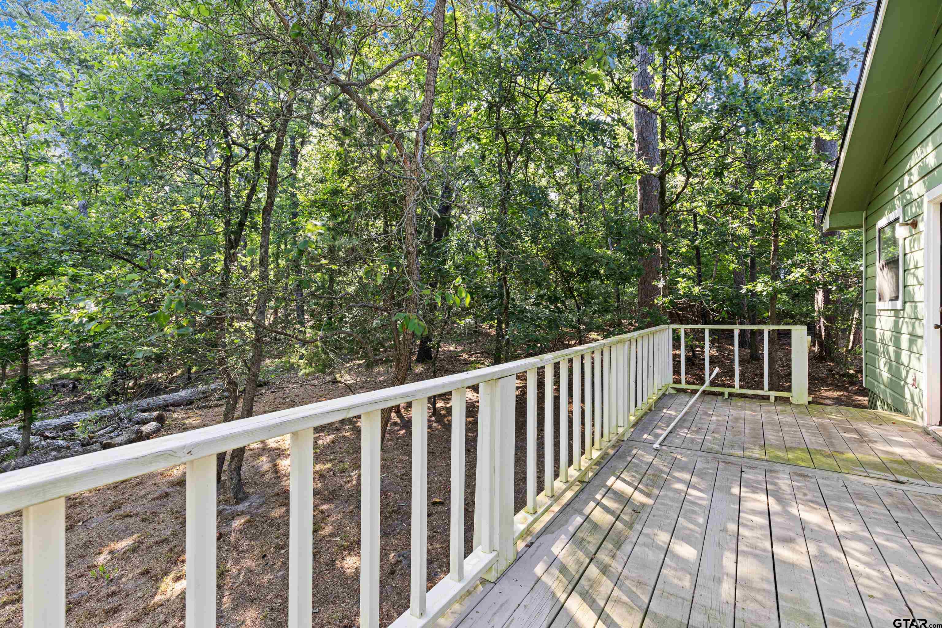 149 Primrose Path Holly Lake Ranch, TX 75765 - Photo 13 of 36 a balcony with wooden floor and fence