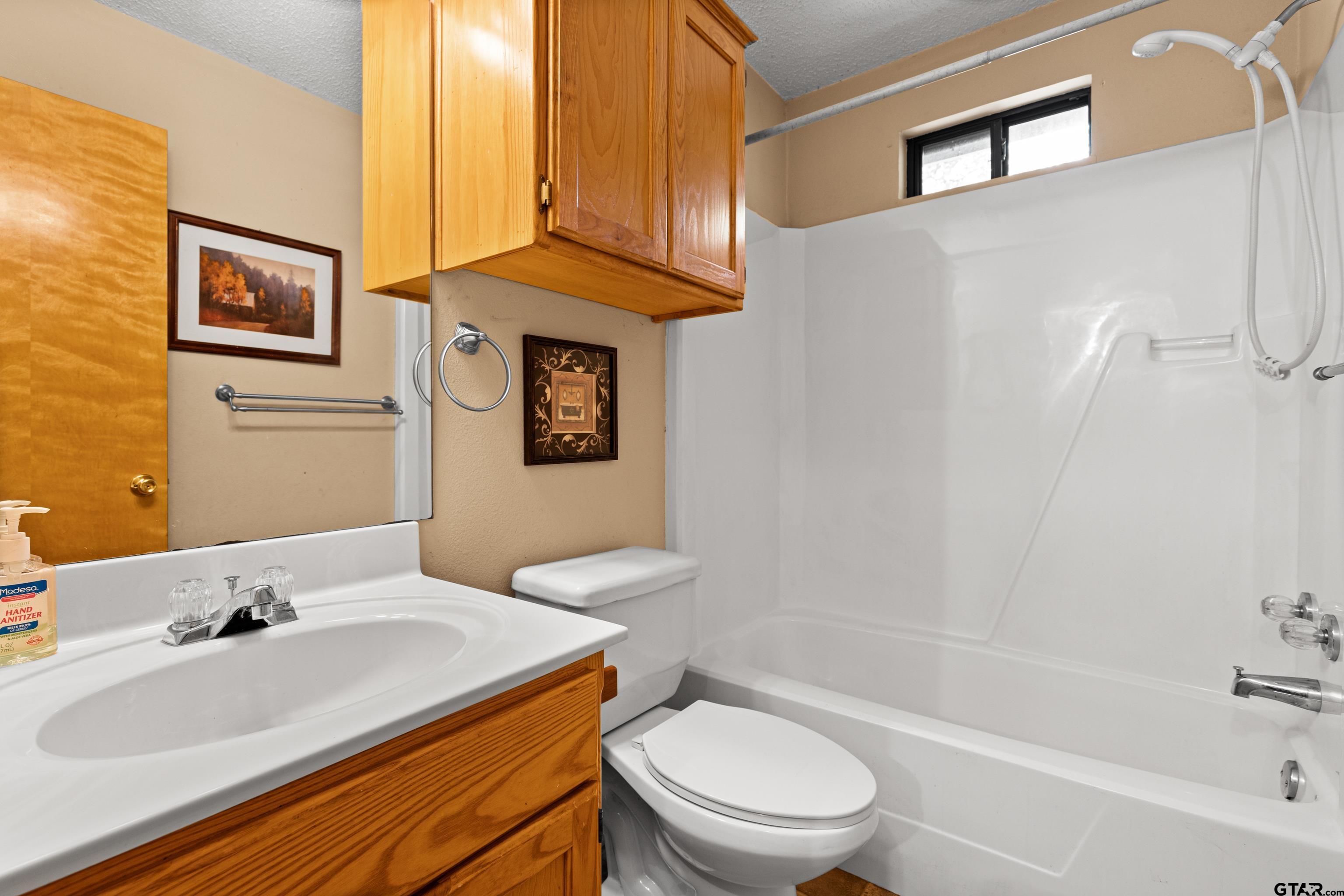 149 Primrose Path Holly Lake Ranch, TX 75765 - Photo 20 of 36 a bathroom with a sink a toilet and shower