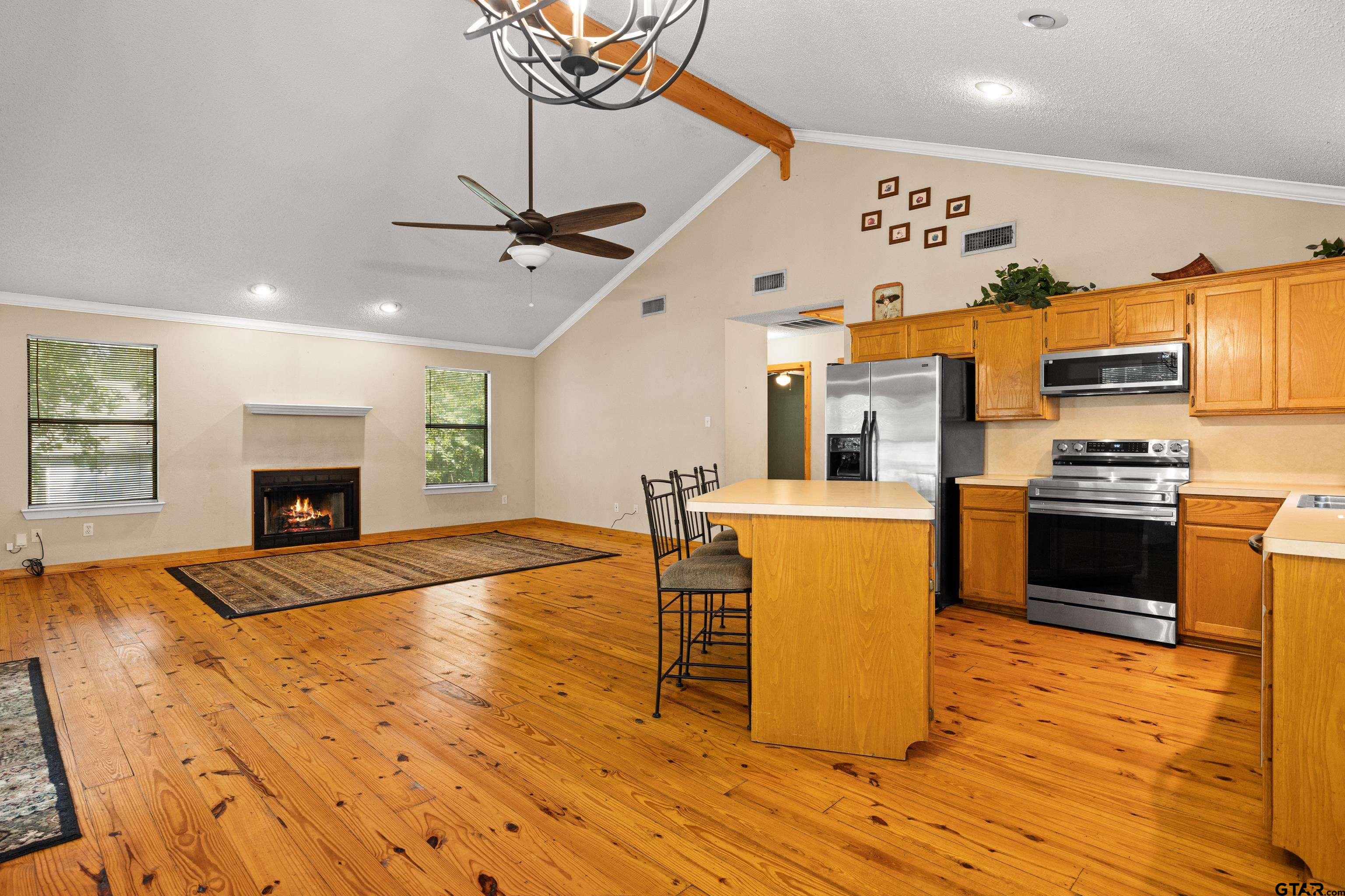 149 Primrose Path Holly Lake Ranch, TX 75765 - Photo 30 of 36 a kitchen with stainless steel appliances a stove top oven a sink a refrigerator cabinets and dining table