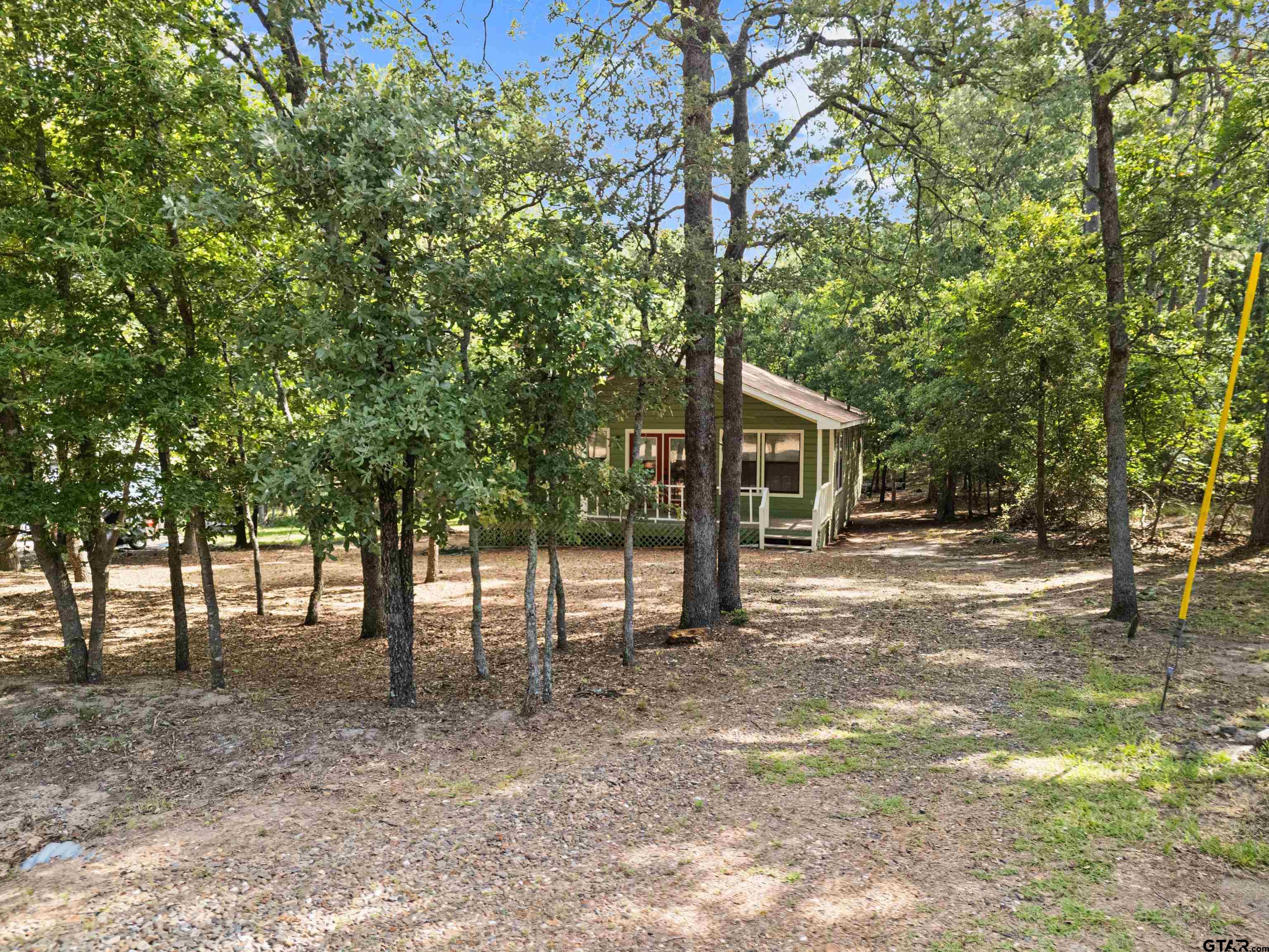 149 Primrose Path Holly Lake Ranch, TX 75765 - Photo 5 of 36 a view of a house with a backyard