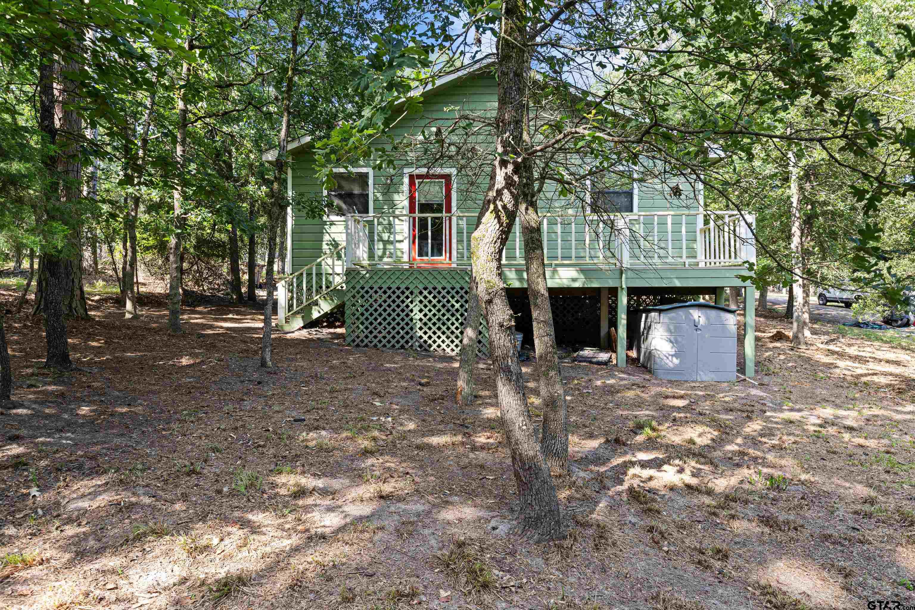 149 Primrose Path Holly Lake Ranch, TX 75765 - Photo 8 of 36 a front view of a house with a tree