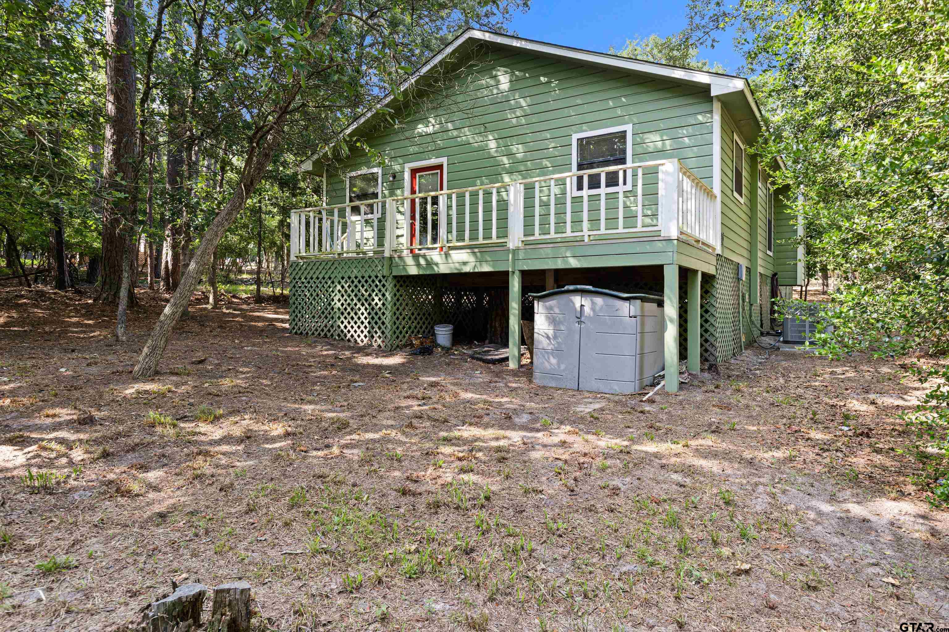 149 Primrose Path Holly Lake Ranch, TX 75765 - Photo 9 of 36 a front view of a house with a yard