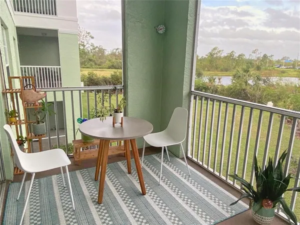 a balcony with table and chairs
