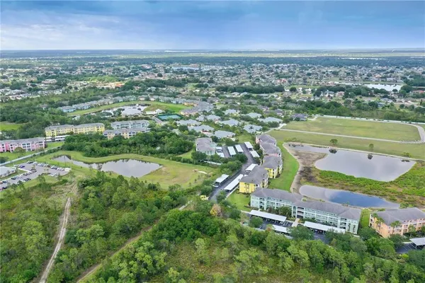 an aerial view of a residential houses with outdoor space and street view