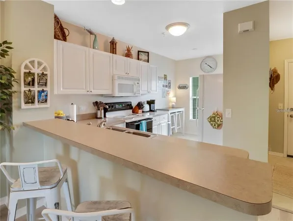 a kitchen with stainless steel appliances cabinets a sink and a stove