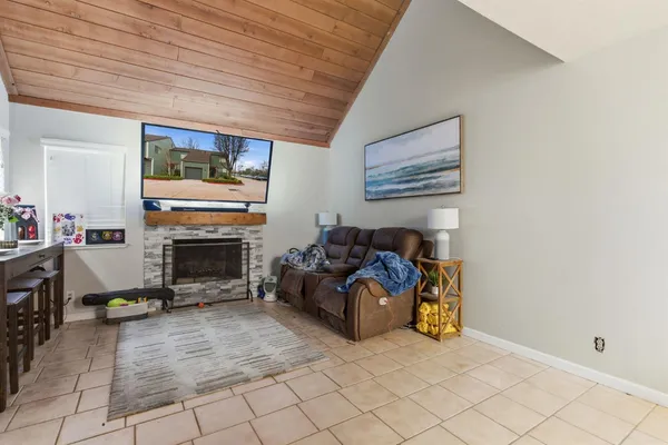 a living room with furniture a fireplace and a table