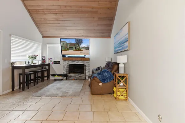 a living room with furniture a fireplace and a table