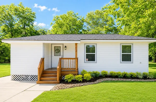 a front view of a house with a yard
