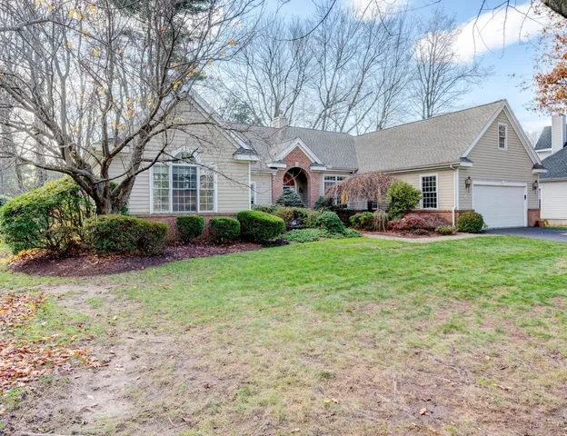 a view of a house with a yard and garden