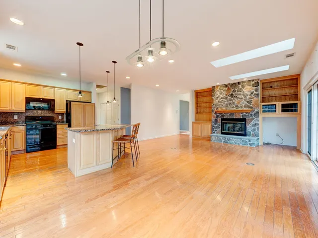 a view of kitchen with stainless steel appliances refrigerator oven and cabinets
