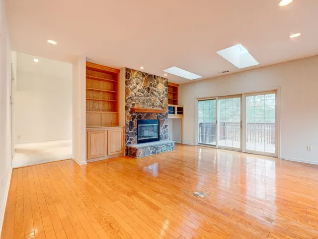 a open kitchen with granite countertop a stove top oven a sink and a dining table with garden view