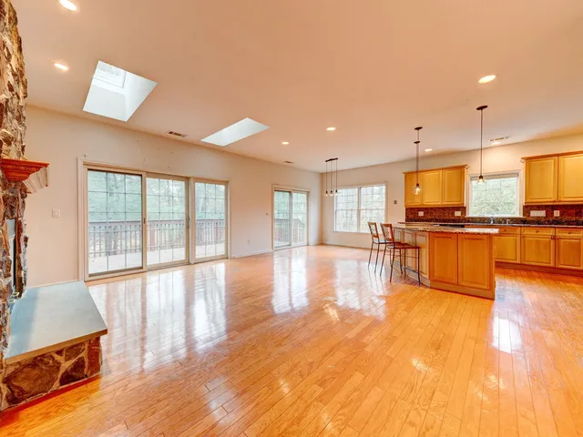 an empty room with a fireplace and wooden floor
